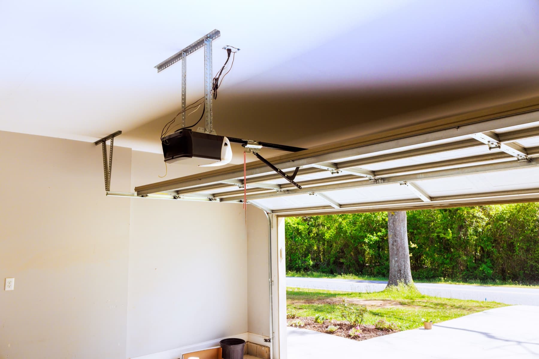 Garage door opener and rail in an open residential garage